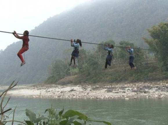 Παιδιά κρέμονται σε συρματόσχοινο για να πάνε σχολείο